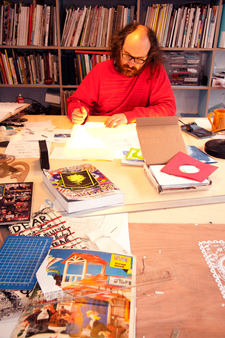 Artist Rob Ryan working in his studio
